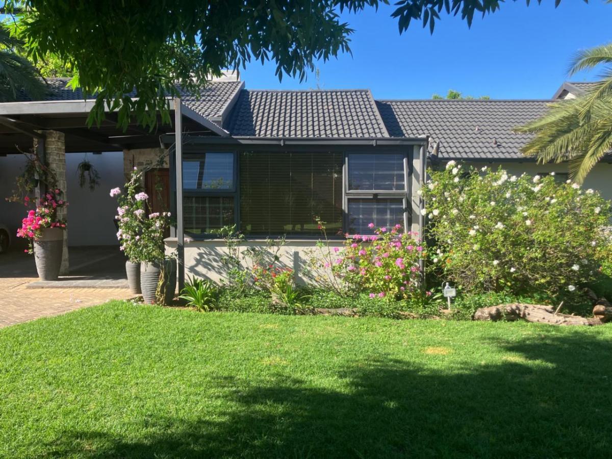 Lush garden lawn and flower beds at At No.7