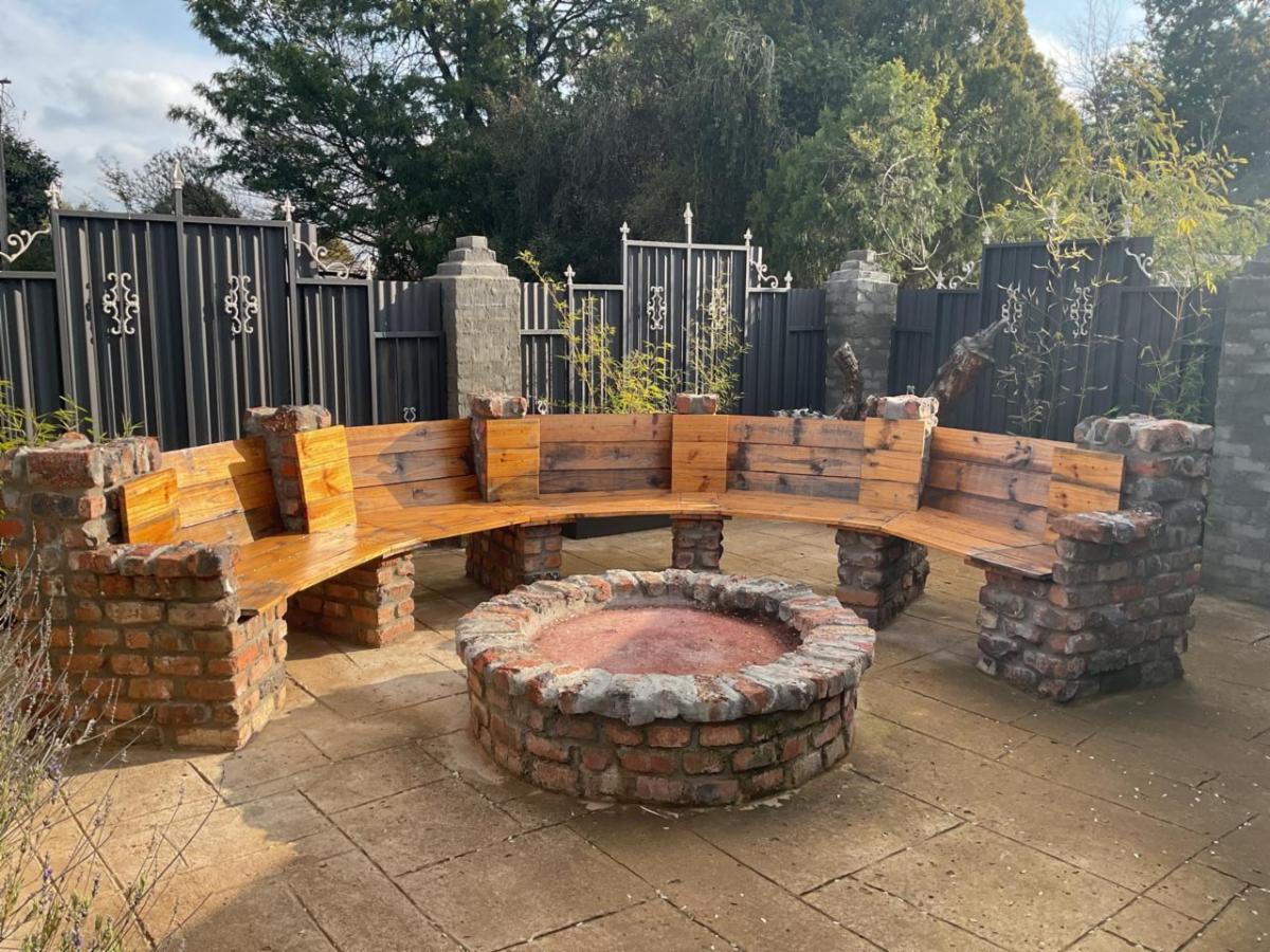 Outdoor fire pit with curved wooden bench